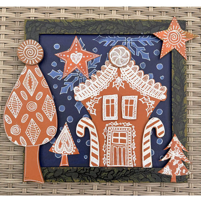 Dyan Reaveley's Dylusions Stampers Anonymous arty crafty example made by Dyan - a gingerbread house made with a Village Cutout Artboard kit and Jigsaw Puzzle Frame kit using Dylusions red rubber art stamps, white fine embossing powder and a little heat to melt the powder to create a glazed faux enamel finish.