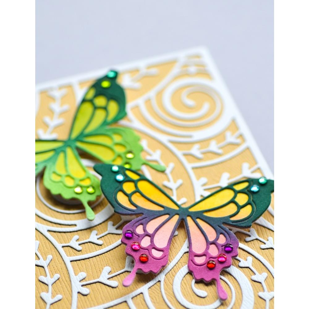Curlicue Plate - Die Cutting Template by Memory Box (no. MB94698). Spirals and arrows curling and overlapping. Design size 4" x 5 1/4" (10.2cm x 13.3cm). 1 (one) template.  This gorgeous design features overlapping spirals of curls and arrows in fine lines, perfect for layering and adding dimension for cards, scrapbook pages, journaling, mixed media of all kinds. Photo of closeup of butterflies resting on the curlicue background.