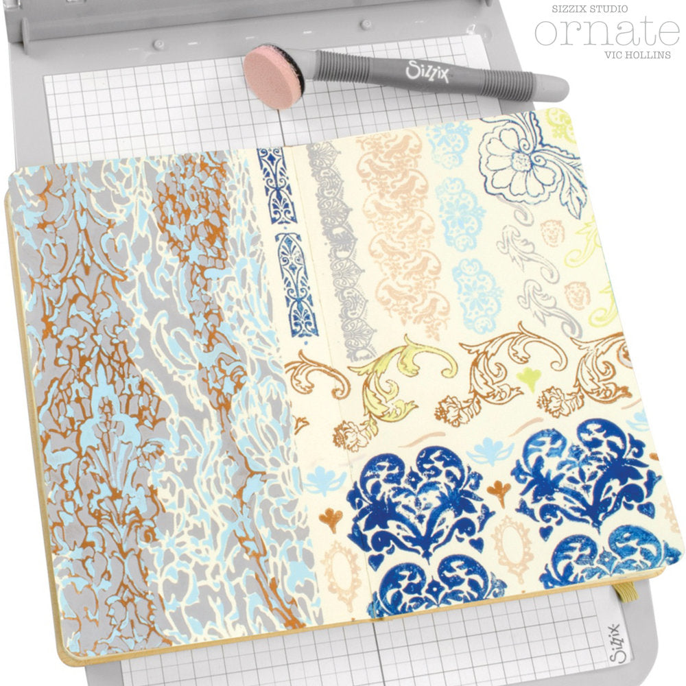 Ornate - Stencils and Stamps ... Sizzix Studio Mixed Media Kit ... by Vic Hollins and Sizzix. Layering art stencils and clear acrylic stamps to use for mixed media, papercrafts, art journaling, visual arts of all kinds. The stamp designs in this set includes beautiful detailed flourishes, floral elements, leafy pattens, birds, a small oval frame, edging and more. A total of 14 stamp designs and 3 stencils. Stencil designs include a pair of rugged abstract stripes and two lacy patterns. Photographic example.