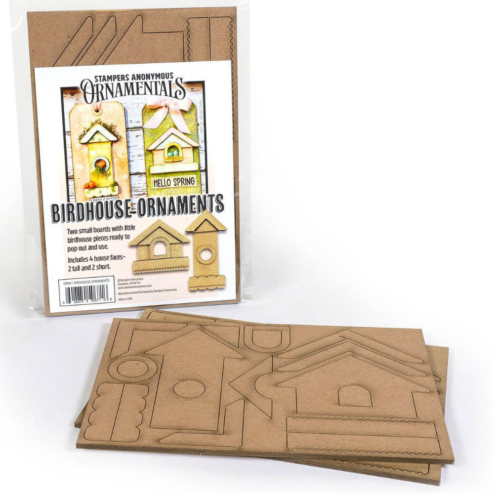 Birdhouse Ornaments - Thickboard Shapes by Stampers Anonymous. 2 (two) sheets of compressed board with precut designs of little bird house pieces, ready to pop out and use to create 4 (four) house faces, 2 short and 2 tall. 18 pieces per sheet. ORN01  Each sheet is 4 1/2" x 6 3/4" and approx 2mm thick. Photograph of the packet next to two sheets of ornaments showing laser cut designs.