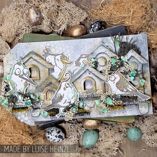 Birdhouse Ornaments - Thickboard Shapes by Stampers Anonymous. 2 (two) sheets of compressed board with precut designs of little bird house pieces, ready to pop out and use to create 4 (four) house faces, 2 short and 2 tall. 18 pieces per sheet. ORN01  Each sheet is 4 1/2" x 6 3/4" and approx 2mm thick. Photograph of an Etcetera tag made by Luise Heinzl, using Tim Holtz Bird Crazy stamps, Idea-Ology and Distress art supplies with the birdhouse pieces.