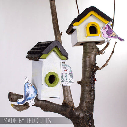 Birdhouse Ornaments - Thickboard Shapes by Stampers Anonymous. 2 (two) sheets of compressed board with precut designs of little bird house pieces, ready to pop out and use to create 4 (four) house faces, 2 short and 2 tall. 18 pieces per sheet. ORN01  Each sheet is 4 1/2" x 6 3/4" and approx 2mm thick. Photograph of two birdhouses made using this kit with additional pieces to create whole boxes with roof tiles. Made by Ted Cutts of Stampers Anonymous.
