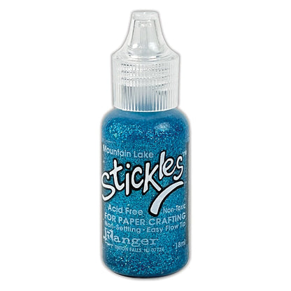 Mountain Lake blue - Stickles by Ranger . Add a touch of magical sparkle everywhere you go with this beautiful and easy to use glitter glue! Stickles is a clear medium infused with an abundance of non-settling super fine sparkly glitters in a wild variety of colours. Use on papercrafts, scrapbooking, mixed media, cardmaking, visual arts of all kinds. Each bottle holds 18ml and has a fine tipped nozzle with an easy squeeze application. Once dry on porous surfaces, it is permanent and does not brush off.