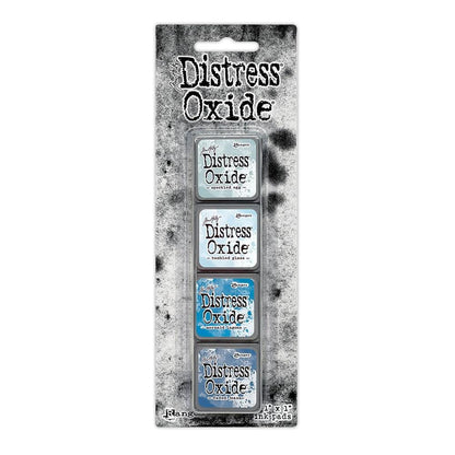Mini Distress Oxide Ink Pads - Set 10 - by Tim Holtz and Ranger ... featuring water-reactive dye and pigment ink fusion that creates an oxidised effect when spattered, stamped, brushed and or sprayed with water. The colours are opaque and dry with a soft matte finish. Set of 4 (four) colours in Mini Ink Pad Cubes (1"x1"), one of each (TDIK91561).

Colours in this set are ...
- Speckled Egg
- Tumbled Glass
- Mermaid Lagoon
- Faded Jeans
... one of each colour.