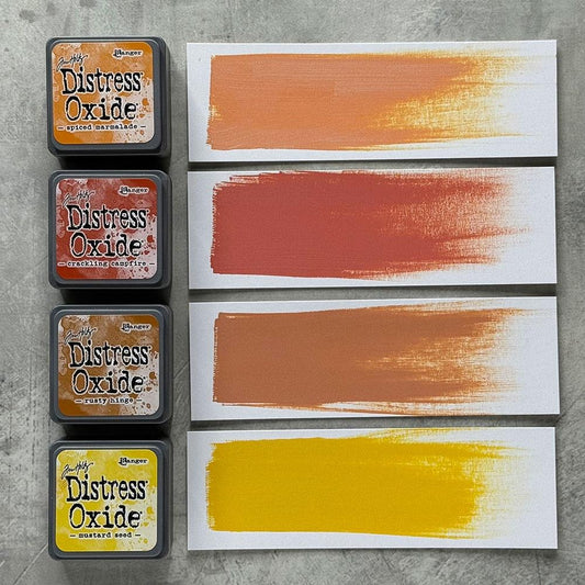 Mini Distress Oxide Ink Pads - Set 2 - by Tim Holtz and Ranger ... featuring water-reactive dye and pigment ink fusion that creates an oxidised effect when spattered, stamped, brushed and or sprayed with water. The colours are opaque and dry with a soft matte finish. Set of 4 (four) colours, one of each (TDIK91486). 
Colours in this set are ...
- Spiced Marmalade
- Crackling Campfire
- Rusty Hinge
- Mustard Seed
... one of each colour.