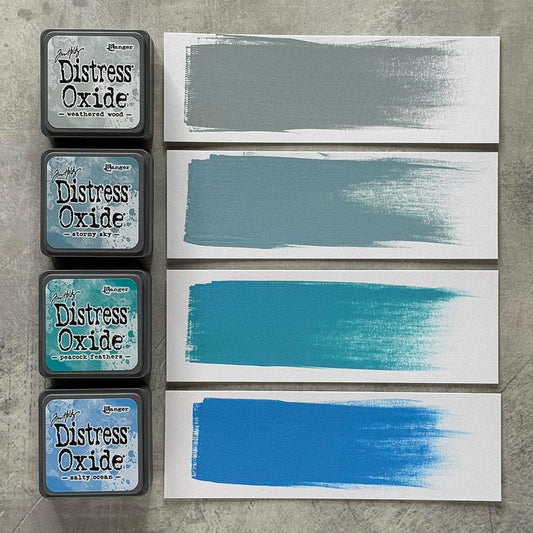 Mini Distress Oxide Ink Pads - Set 4 - by Tim Holtz and Ranger ... featuring water-reactive dye and pigment ink fusion that creates an oxidised effect when spattered, stamped, brushed and or sprayed with water. The colours are opaque and dry with a soft matte finish. Set of 4 (four) colours, one of each (TDIK91509).

Colours in this set are ...
- Weathered Wood
- Stormy Sky
- Peacock Feathers
- Salty Ocean
... one of each colour.