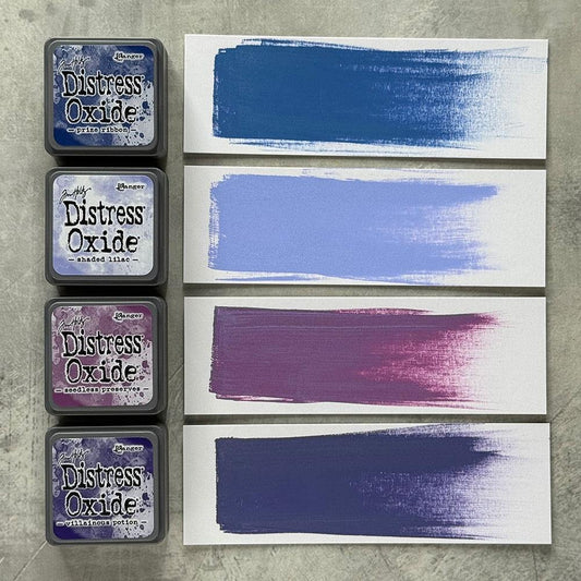 Mini Distress Oxide Ink Pads - Set 5 - by Tim Holtz and Ranger ... featuring water-reactive dye and pigment ink fusion that creates an oxidised effect when spattered, stamped, brushed and or sprayed with water. The colours are opaque and dry with a soft matte finish. Set of 4 (four) colours, one of each (TDIK91516).

Colours in this set are ...
- Prize Ribbon
- Shaded Lilac
- Seedless Preserves
- Villainous Potion
... one of each colour.