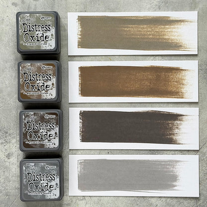 Mini Distress Oxide Ink Pads - Set 12 - by Tim Holtz and Ranger ... featuring water-reactive dye and pigment ink fusion that creates an oxidised effect when spattered, stamped, brushed and or sprayed with water. The colours are opaque and dry with a soft matte finish. Set of 4 (four) colours in Mini Ink Pad Cubes with 1" square raised felt, one of each (TDIK91585).

Colours in this set are ...
- Frayed Burlap
- Gathered Twigs
- Ground Espresso
- Hickory Smoke
... one of each colour. Photo example.