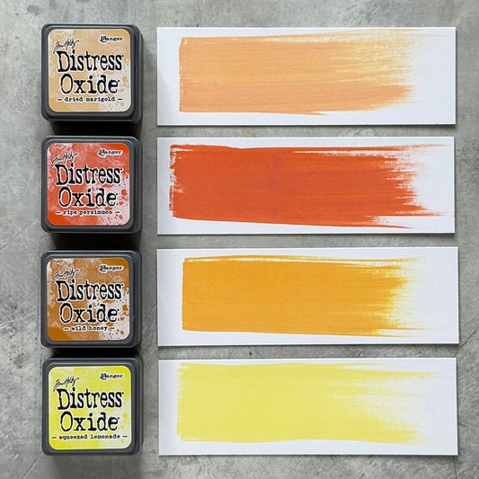 Mini Distress Oxide Ink Pads - Set 8 - by Tim Holtz and Ranger ... featuring water-reactive dye and pigment ink fusion that creates an oxidised effect when spattered, stamped, brushed and or sprayed with water. The colours are opaque and dry with a soft matte finish. Set of 4 (four) colours in Mini Ink Pad Cubes with 1" square raised felt, one of each (TDIK91547).

Colours in this set are ...
- Dried Marigold
- Ripe Persimmon
- Wild Honey
- Squeezed Lemonade
... one of each colour. Photographic example