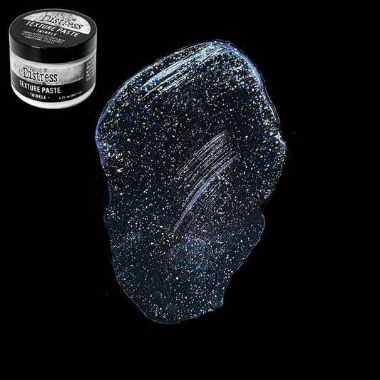 Twinkle - Texture Paste, Translucent, Shimmery and Shiny - Tim Holtz Distress dimensional medium with clear coverage, sparkly glittery highlights and gloss finish, 3fl oz (88.7ml) jar. Made by Ranger. Tim Holtz Distress® Texture Paste Twinkle is a translucent gloss paste with glitter flecks for dimensional effects. The gorgeous Distress Twinkle Texture Paste can be altered and stained to enable endless colourful possibilities for creativity. Photo on black.