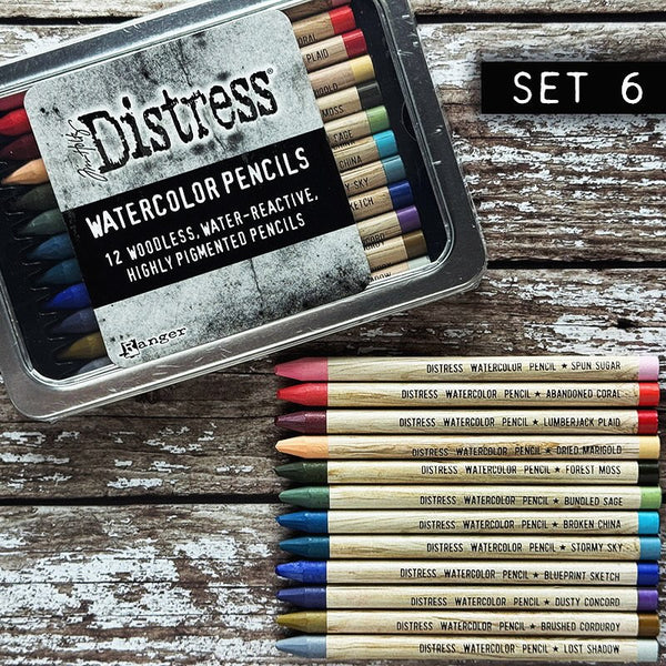 Woodless Watercolour Pencils in Distress colours, set 6 ... by Tim Holtz and Ranger. 12 (twelve) woodless watercolour pencils in Spun Sugar, Abandoned Coral, Lumberjack Plaid, Dried Marigold, Forest Moss, Bundled Sage, Broken China, Stormy Sky, Blueprint Sketch, Dusty Concord, Brushed Corduroy, Lost Shadow. One of each colour, approx 5" long. Photo of the tin of pencils with 12 loose ones.