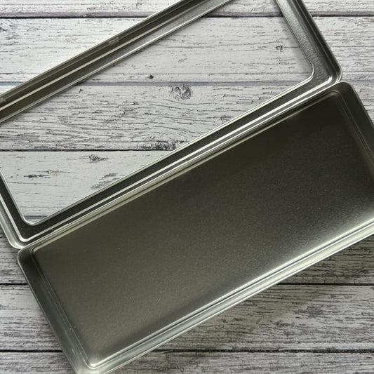 Spritz Distress Storage Tin ... by Tim Holtz and Ranger - 1 (one) empty metal container with hinged lid and window. Designed to fit 12 (twelve) bottles of Distress Spritz Sprays (sold separately). Organise and transport your Distress essentials and other arty treasures easily in this convenient stylish lightweight container. Features a clear window on a hinged lid which has a snug closure to keep it closed during transit. Photo of an open Distress Spritz tin.
