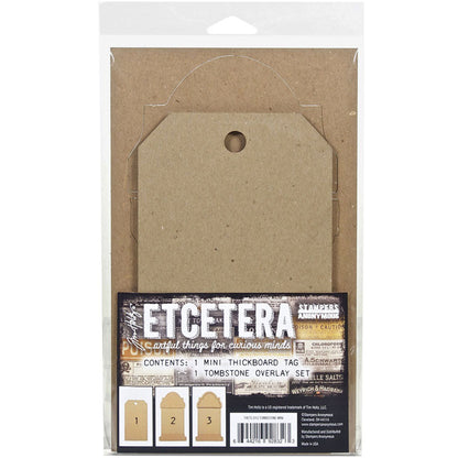 Tombstone Tag Set, Mini - Etcetera Thickboards ... by Tim Holtz and Stampers Anonymous. 1 (one) tag 4.5" x 8" in size with a gravestone overlay kit of top, frame and base. Perfect for all kinds of Halloween makes including wallart, gift tags, displays, dioramas, home decor and visual arts. Tim Holtz Etcetera tags are artful things for curious minds! Tim Holtz Etcetera Thickboard is a kraft brown hardboard substrate, a 2-3mm thick wood-like material used for mixed media.  Cello Pack.