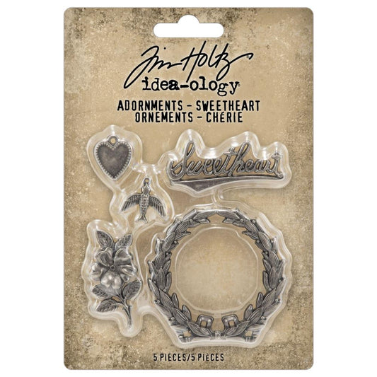 Sweetheart ... Idea-Ology Adornments by Tim Holtz. 5 (five) pieces, made of metal to use for mixed media, decorating ornaments, home decor makes and visual arts. Tim Holtz Idea-Ology Metal Adornments are finished in an antique style pewter colour. The designs feature a round leafy wreath, heart charm, flying bird charm, the word sweetheart in a vintage script and a little flower with leaves. TH94363