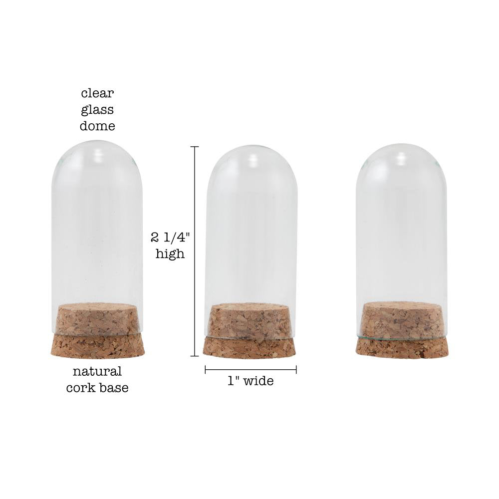 Glass Display Domes, Mini, with Cork Bases ... by Tim Holtz Idea-Ology - Use for mixed media, assemblage projects, off-the-page marvels and party decor. Pack of 3 (three) tall narrow glass displays with domed shape and natural cork bases. Size is 25mm x 50mm tall, plus the height of the corks. Add to your project, off-the-page marvel, canvas or other artistic creation and attach using trimmings, fasteners or collage medium. Alter using alcohol inks, texture pastes, Distress crayons or Distress paints.