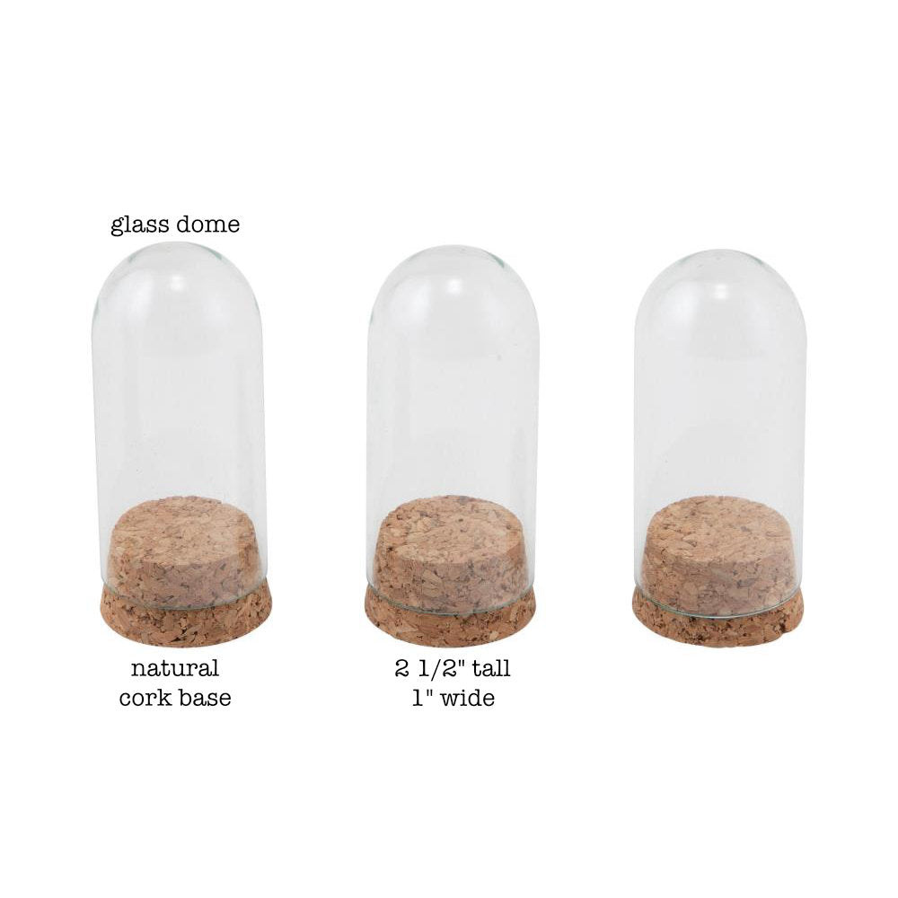 Glass Display Domes, Mini, with Cork Bases ... by Tim Holtz Idea-Ology - Use for mixed media, assemblage projects, off-the-page marvels and party decor. Pack of 3 (three) tall narrow glass displays with domed shape and natural cork bases. Size is 25mm x 50mm tall, plus the height of the corks. Add to your project, off-the-page marvel, canvas or other artistic creation and attach using trimmings, fasteners or collage medium. Alter using alcohol inks, texture pastes, Distress crayons or Distress paints.
