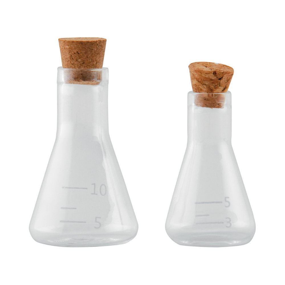 Laboratory Glass Flasks with Corks ... by Tim Holtz Idea-Ology - Use for mixed media, assemblage projects, off-the-page marvels and party decor. Pack of 2 (two) triangular shaped glass bottles with cork lids. Sizes are 24mm x 42mm tall and 30mm x 54mm tall, plus the height of the little corks. One of each size. Add to your project, off-the-page marvel, canvas or other artistic creation and attach using trimmings, fasteners or collage medium. TH94144