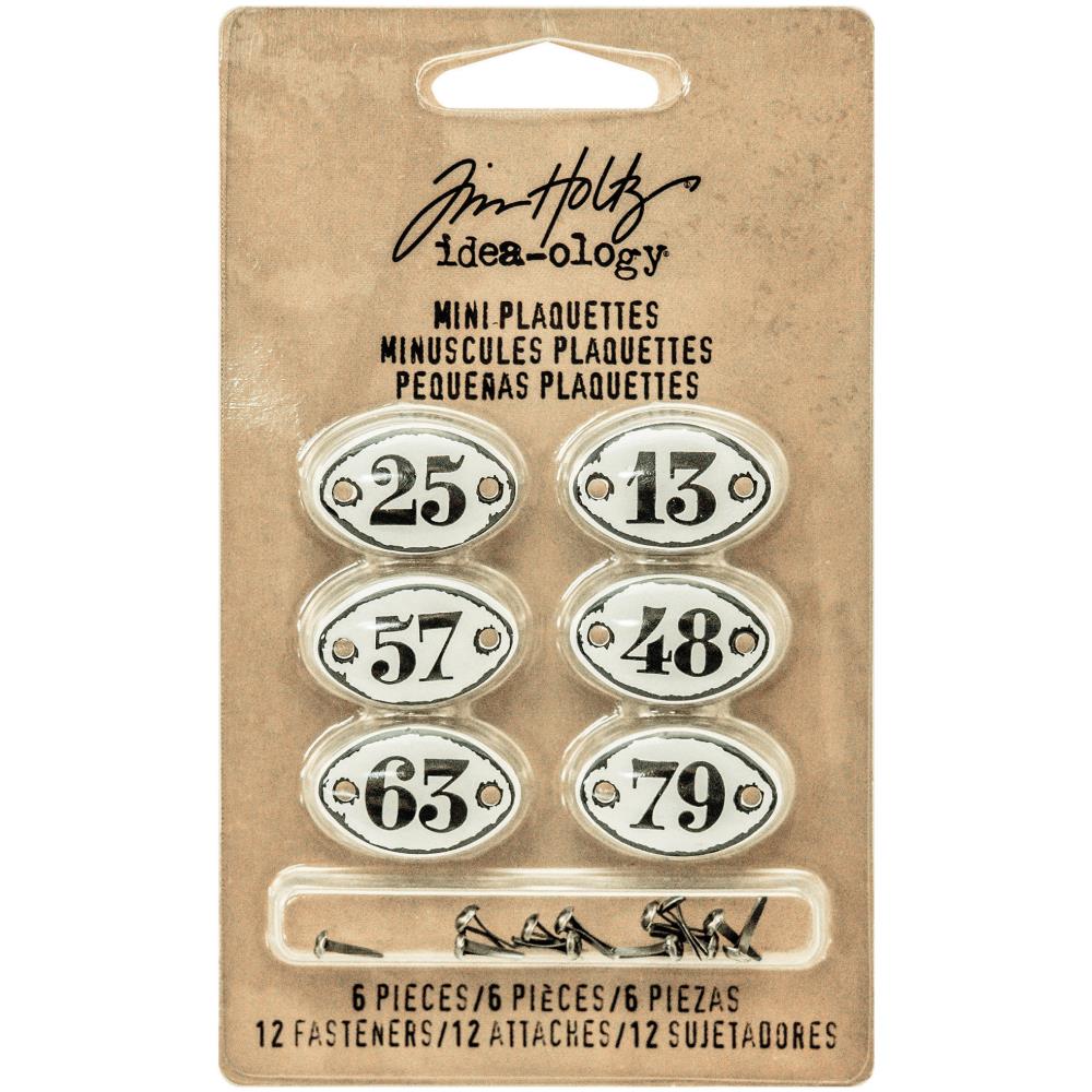Mini Plaquettes (with fasteners) ... Idea-Ology Adornments by Tim Holtz. Oval plaques with black numerals on white enamel background with predrilled holes for attaching to mixed media, decorating ornaments, home decor makes and visual arts of all kinds. 6 (six) plaques (one of each) 3/4" x 1/2" in size, 12 (twelve) metal split pins (brads, tiny screw-top fasteners).