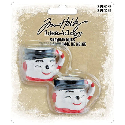 Snowman Mugs - Idea-Ology Resin Models ... by Tim Holtz - Miniature 1 1/8" high dimensional Frosty the Snowman styled character mugs made of resin for decor, assemblage projects, diorama, off-the-page marvels and party decor. Pack of 2 (two) mugs. Each mug is shaped into the smiling face of a snowman with black hat, red scarf, and a red-white striped handle. TH94501