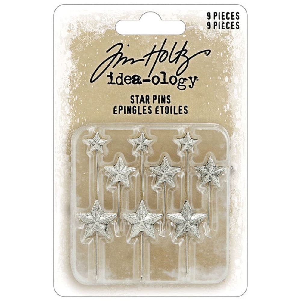 Star Pins, Christmas 2026 ... Idea-Ology Adornments by Tim Holtz. Beautifully made silver coloured sharp pins topped with 5-pointed stars, to use as embellishments for Christmas and other celebrations on display makes, dioramas, mixed media, paper crafts, mixed media and visual arts. 9 (nine) pins, 3 of each sized star. TH94498. Photo of the stars within packaging.