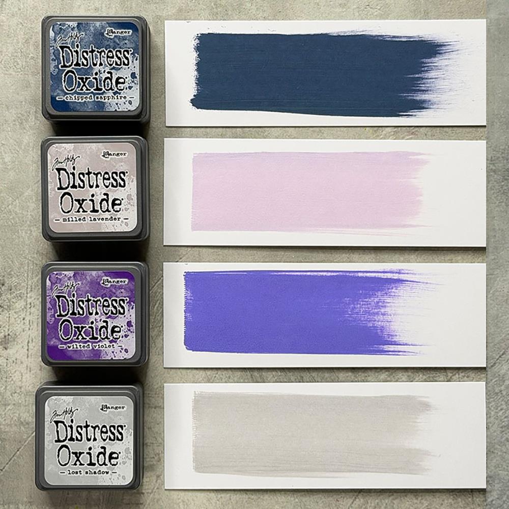 Mini Distress Oxide Ink Pads - Set 17 - by Tim Holtz and Ranger ... featuring water-reactive dye and pigment ink fusion that creates an oxidised effect when spattered, stamped, brushed and or sprayed with water. The colours are opaque and dry with a soft matte finish. Set of 4 (four) colours in Mini Ink Pad Cubes with 1" square raised felt, one of each (TDIK91639).

Colours in this set are ...
- Chipped Sapphire
- Milled Lavender
- Wilted Violet
- Lost Shadow
... one of each colour.