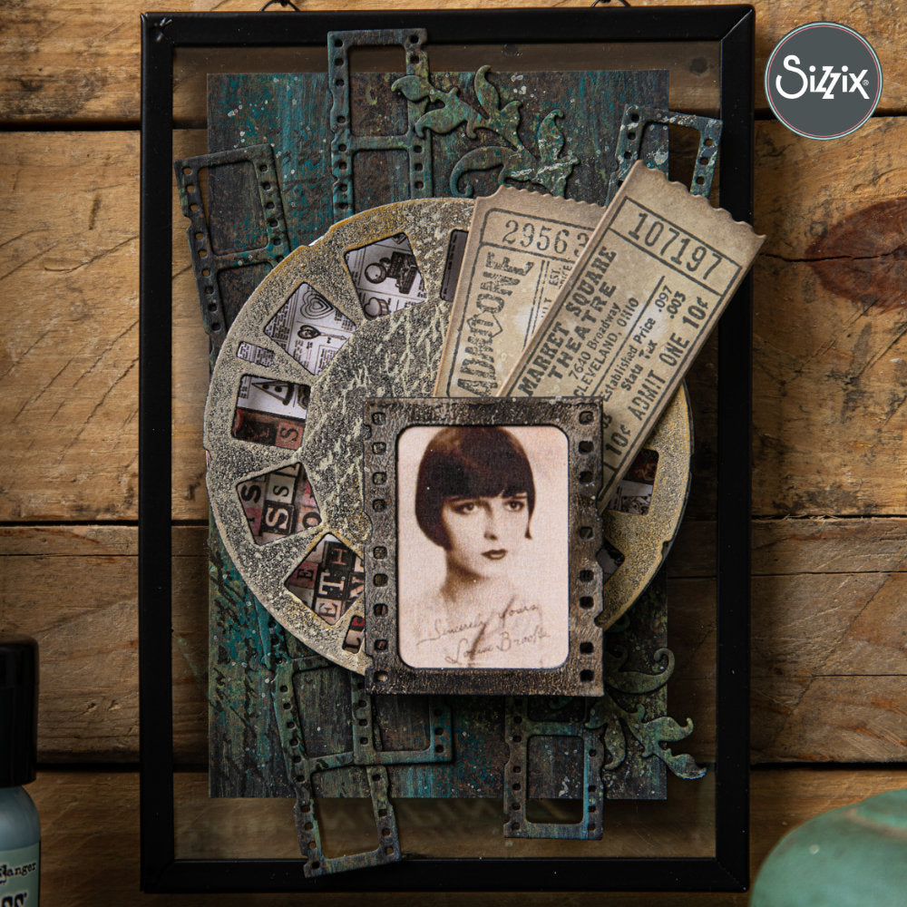 framed layered rustic artwork by Sizzix  - using Picture Show - from the Vault ... Thinlits Die Cutting Templates by Tim Holtz and Sizzix (no.666602). Brought back to life by Tim and Sizzix, these vintage designs have been reimagined as in a different size for art and creativity. These designs cut out various pieces relating to photography, film making and framing. A long film strip, vintage picture wheel, a slide or single negative film strip, plus various squares and rectangles to match.