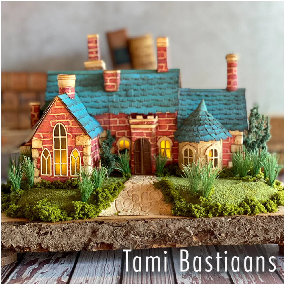 Village Collection ... Thinlits - Die Cutting Templates by Tim Holtz and Sizzix (product id 665564). Imagine building a miniature row of buildings with all their features ease! Create the shape of a building and add steeples, windows, tiles, doors, chimneys, all with depth, colour variations and 3D elements without spending hours fussy cutting with scissors. Photo of beautiful home with teal tiled roof by Tami Bastiaans.
