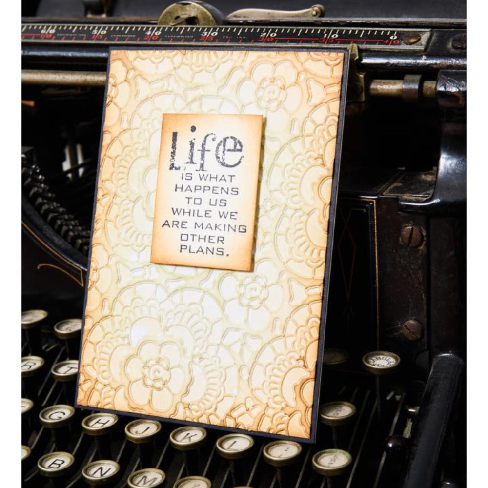 Lace - Texture Fades Embossing Folder ... by Tim Holtz and Sizzix (no.666865). Inspired by vintage lacework, doilies, curtains and tablecloths, this embossing folder creates a beautiful pattern to use with paper, vellum and cardstock. The detailed design and linework create amazing dimensional texture, ideal for all kinds of papercrafts, pockets, junk journals, scrapbook pages, card backgrounds, anything you wish to make! Photo of a card with embossed lace.