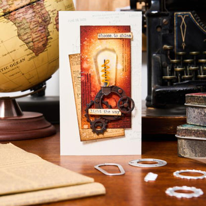 Industrial - Sizzix Thinlits die cutting templates by Tim Holtz. 37 (thirty seven) assorted patterns and shapes for a complete steampunk makeover including vintage lightglobe, gauge or dial, gears, numbers, pipes and corners, tap, drip, round washer, arrow bolt tops and more (no.666874). Photo of card ideas.