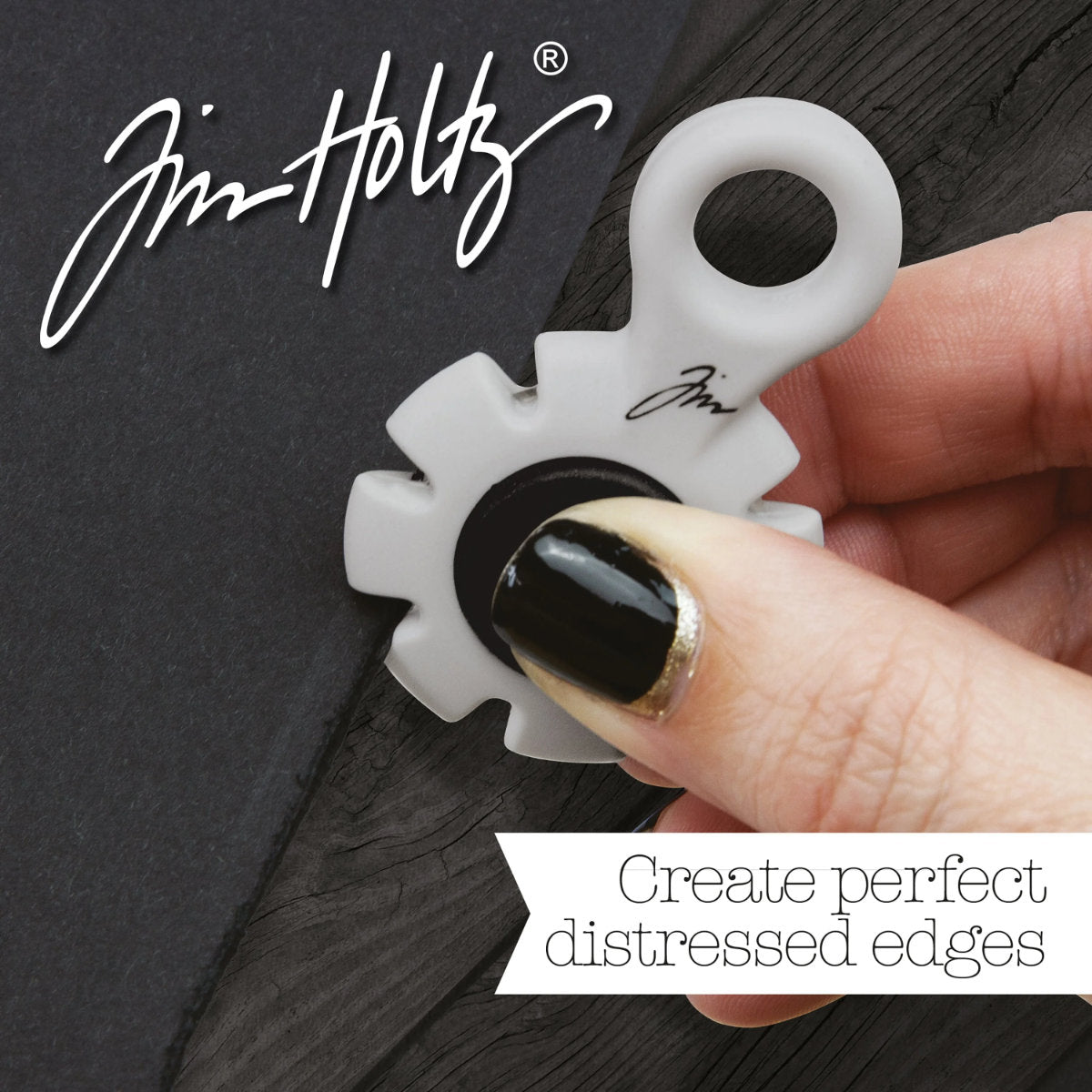 Paper Distresser - by Tim Holtz and Tonic Studios ... this is a tool for roughing up paper, cardstock edges and cutting threads in papercrafts, mixed media and tactile crafts. Includes a Kushgrip holder, hanging loop and 7 sharp recessed edges. Ergonomic Kushgrip round centre spot for comfort during handling, with very sharp steel blades recessed within the grey round plastic surround. It is safe to hold and easy to use. Photo from Tonic Studios of tool in use.