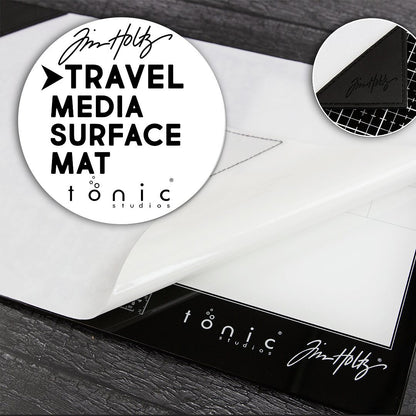 Small (Travel Sized) Media Surface Mat by Tim Holtz and Tonic Studios ... Travel Sized 15.5" x 10" heavy duty, non stick and heat resistant craft workspace with weighted reinforced corners ... designed to use as a stand alone craft mat or with Tim's Travel Sized Glass Media Mats (all sizes also available, each sold separately) as well as on its own. Photo of the glass mat with notes.