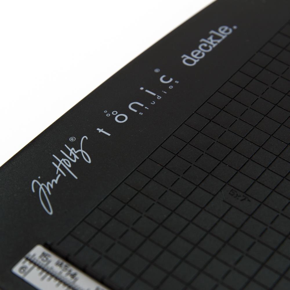 close up photo of the base platform with grid - Tim Holtz Deckle (Torn Edge) Blade Guillotine Paper Cutter - with a unique torn edge style blade, ergonomic comfort Kushgrip handle. Use to create the look of rugged torn edges to paper and cardboard easily and quickly. Made by Tonic Studio with precision ground, ultra sharp blade with a rough ragged pattern, this strong trimmer is built to last.