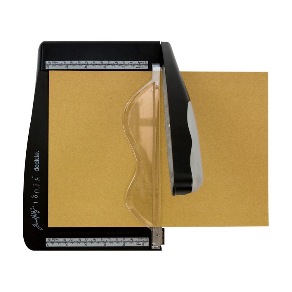 top view photo of Deckle Blade Trimmer by Tim Holtz and Tonic Studio with kraft heavystock - Tim Holtz Deckle (Torn Edge) Blade Guillotine Paper Cutter - with a unique torn edge style blade, ergonomic comfort Kushgrip handle. Use to create the look of rugged torn edges to paper and cardboard easily and quickly. Made by Tonic Studio with precision ground, ultra sharp blade with a rough ragged pattern, this strong trimmer is built to last.