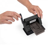Tim Holtz Sidekick by Sizzix, portable black die cutting and embossing machine, photo shows the machine being used