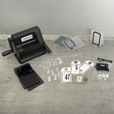 Tim Holtz Sidekick by Sizzix, portable black die cutting and embossing machine, photo shows the machine with all the accessories and instruction booklet