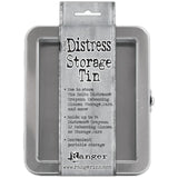 Distress Storage Tin ... by Tim Holtz and Ranger - 1 (one) empty metal container with hinged lid and window. Originally named the "Distress Crayon Storage Tin". Holds up to ... - 34 x Distress Crayons, - 12 x Distress Embossing Glaze, - 12 x Ranger and Distress 1oz sized jars, - 12 x jars of Ranger Stickles Gel, - 70 x Distress Woodless Watercolour Pencils, - 4 x rolls of Idea-Ology Collage paper, ... and anything else you can fit in this handy sized tin.  Tin size : (approx) 6" x 7" x 2".