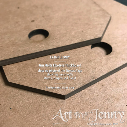 closeup photograph showing an example of the Etcetera Thickboard by Tim Holtz and Stampers Anonymous. Etcetera Thickboard Tags, Small ... by Tim Holtz - 3 (three) hardboard pieces, each 5.5" x 10", 3mm thick. Tim Holtz Etcetera Thickboard is a kraft brown hardboard substrate, a 2-3mm thick wood-like material used for mixed media. Etcetera tags are made with compressed paper, made to have the look and feel of mdf or craftwood.