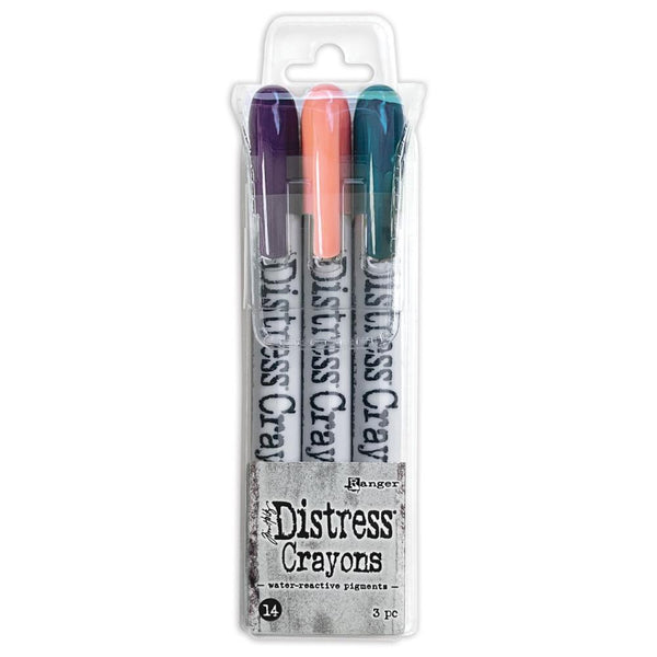 Distress Crayons - Set 14 ... by Tim Holtz. 3 (three) colours (Villainous Potion, Saltwater Taffy, Uncharted Mariner) of aquarelle pastels, watersoluble crayons in a twist-style barrel / holder with lid. One of each colour.   Colours in this set are : - Villainous Potion (dark purple) - Saltwater Taffy (light peachy pink) - Uncharted Mariner (dark turquoise). 