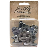 Metal Hinge Clips, Small - 3/4" (19mm) wide ... by Tim Holtz - 15 (fifteen) metal clips with hinged opening, used to attach and hold artwork, memorabilia and other items together. Each is 3/4" or 19mm wide.   Inspired by antique stationery clips, these versatile spring loaded clips are so useful for attaching and holding tiny objects and embellishments to tags, photos, books, lists, pages and other creations. TH92692