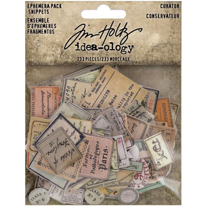 Curator - Snippets Ephemera ... Die Cut Embellishments and Layers - by Tim Holtz Idea-Ology. Over 230 little pieces of labels and vintage imagery printed on fine paper, precut and ready to use in visual arts and papercrafts. Use for junk journals, tags, embellishing envelopes, mixed media, card making, assemblage projects, using as labels for tiny bottles, decorating seasonal display makes, layering in collage. Pack of 233 little tiny die cut paper pieces. Sizes and designs vary up to an inch wide. TH94152