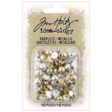 Droplets, Gold and Silver - by Tim Holtz Idea-Ology - dome shaped (semi-sphere) lightweight dimensional embellishments with flat backs in metallic colours of gold and silver. Super shiny and beautiful. Pack of 192 pieces in various sizes (TH94289).  Droplets add vintage metallic dimensional element to your book covers, journals, junk journaling, scrapbook pages, card making, assemblage projects, off-the-page marvels and party decor. Finished in a shiny metallic colourings of bright gold and silver. 