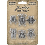 Entomology - Idea-Ology Adornments - by Tim Holtz - 6 (six) silver coloured metal embellishments to use in papercrafts, jewellery making and visual arts. 1 of each design.  Metal Adornments 'Entomology' is a collection of flying insects - 1 scarab, 1 cicada, 1 bee, 1 wasp and 2 beetles. Each insect has amazing detail in their bodies, feet, antennae and wings. Designed to sit flat on the page with a hollow underside to help them sit flat on your page.