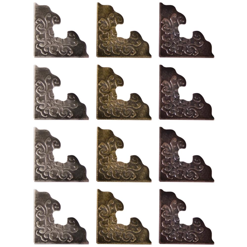 example of the 12 Corners ... by Tim Holtz Idea-Ology - Metal ornate adornments to decorate corners of book covers, canvas, boxes or photos. This package contains 12&nbsp;(twelve) pieces, 4 (four) of each colour.  Designed by Tim Holtz as part of his Idea-Ology range. Made by Advantus Corp. TH92789