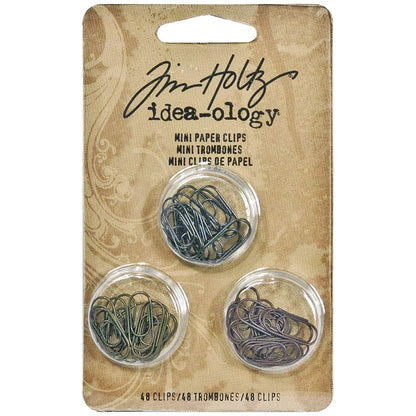 Idea-Ology Paper Clips ... by Tim Holtz - mini metal paperclips used to attach things to other things - papers, fabrics, cards, ephemera. 48 (forty eight) paperclips, 1.5cm (1/2") long, 3 antique colours (16 of each). TH92791.

Inspired by antique stationery fasteners, these small and versatile paper clips are perfect for attaching anything to anything - including ribbons, tinsel, yarn, paper, buttons, trinkets and other embellishments together.