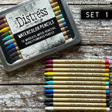 Distress Watercolour Pencils, set 1 ... by Tim Holtz. 12 (twelve) woodless watercolour pencils in Picked Raspberry, Fired Brick, Rusty Hinge, Mustard Seed, Peeled Paint, Salvaged Patina, Speckled Egg, Salty Ocean, Villainous Potion, Walnut Stain, Black Soot, Picket Fence. One of each colour. 
