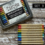 Distress Woodless Watercolour Pencils, set 3 ... by Tim Holtz. 12 (twelve) woodless watercolour pencils in Tattered Rose, Candied Apple, Crackling Campfire, Wild Honey, Crushed Olive, Rustic Wilderness, Peacock Feathers, Tumbled Glass, Faded Jeans, Shaded Lilac, Frayed Burlap, Hickory Smoke. One of each colour, approx 5" long.