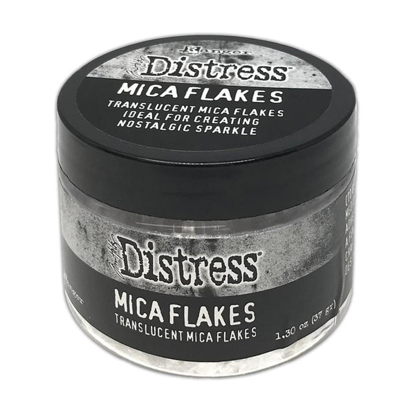 Mica Flakes ... by Tim Holtz Distress - translucent (clear) white pearl mica flakes, 1.3 oz (37 gram) wide opening jar.    This jar of shimmery Mica Flakes is beautiful to look at, easy to work with and simple to clean up. These beautiful clear and clean Distress Mica Flakes are soft and light.