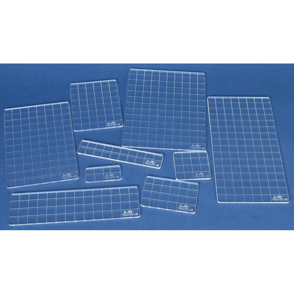 overview of Acrylic Grid Blocks ... by Tim Holtz and Stampers Anonymous - set of 9 (nine) Clear Acrylic Blocks (3mm thick) marked with gridlines at .5 inch intervals. Use for stamping, measuring, using as guides in papercrafts and visual arts.   This set of thin, light and durable stamping blocks are made of 3mm thick acrylic with an etched grid pattern on one side to help with placement - use the lines to align stamps or keep lettering straight.