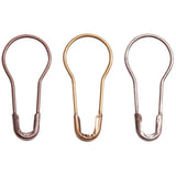 Loop Pins ... by Tim Holtz Idea-Ology - bottle shaped metal safety pins, used to attach charms, ephemera and tags to mixed media, display decor makes and other projects. Pack of 24 (twenty four) pins, 20mm long. Example of the pins.