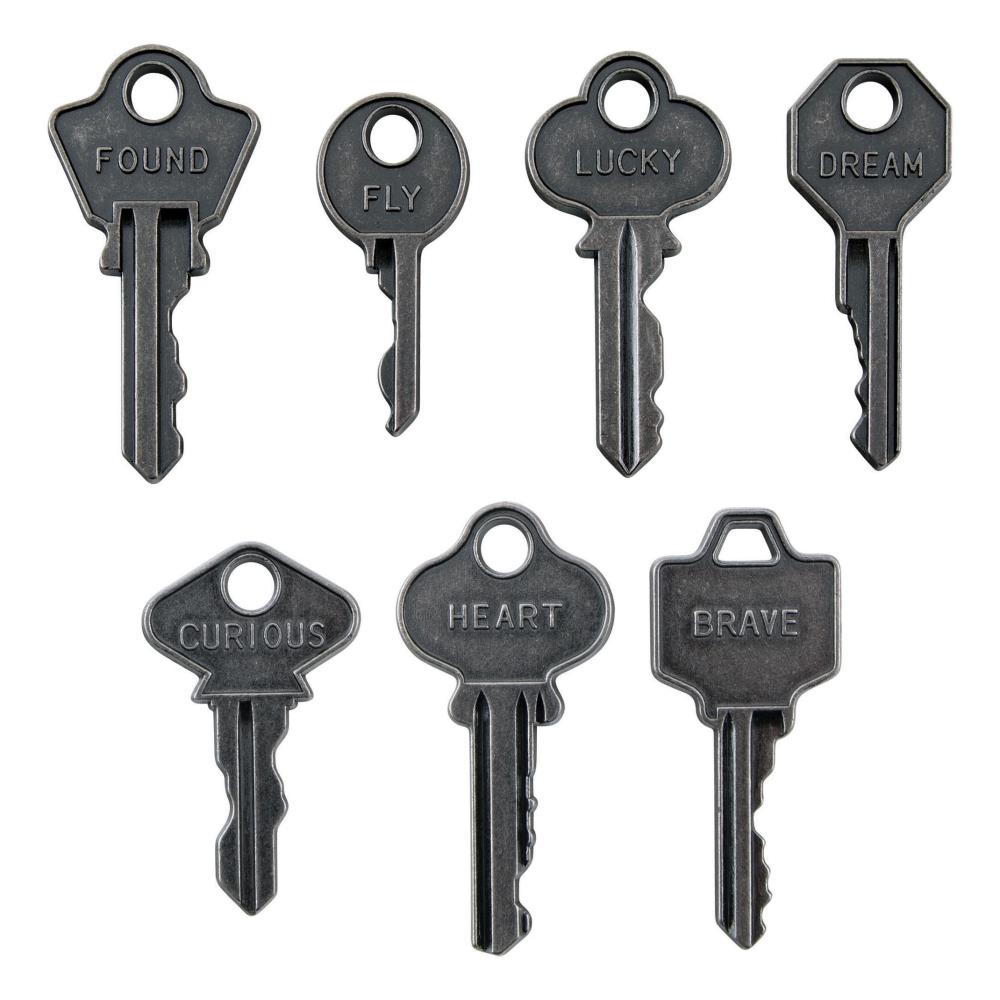 example of Word Keys, Metal Adornments ... by Tim Holtz Idea-Ology - Realistic metal silver coloured keys with words engraved. Use for mixed media, assemblage projects, off-the-page marvels and party decor. 7 (seven) pieces, 1 (one) of each design. The wonderful vintage styling of these Metal Adornment Word Keys are a vintage silver colour, designed by Tim Holtz to enhance your project with a thoughtful word on a uniquely shaped piece - words are : found, fly, lucky, dream, heart, curious, brave.